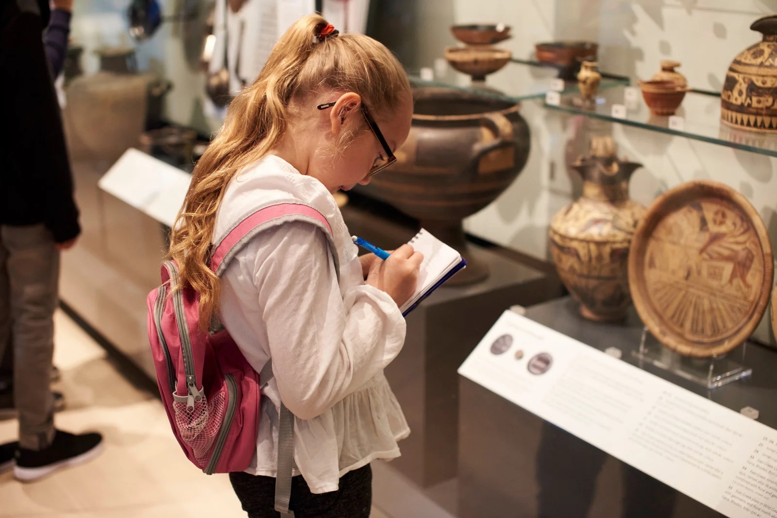 Student writing assignment in museum